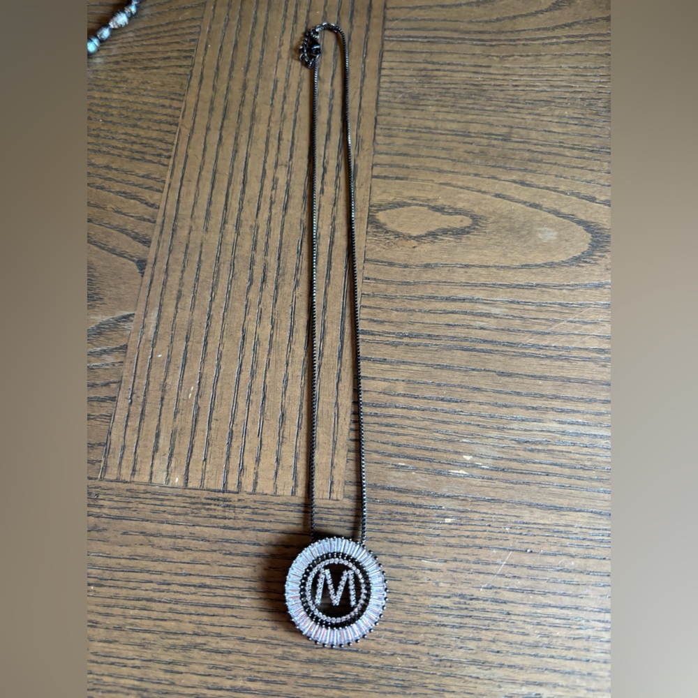 Sis Kiss black gun metal initial necklace.